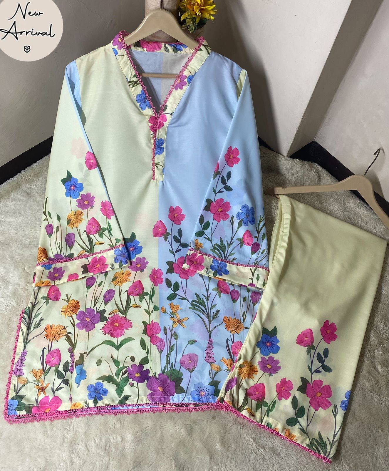 Floral-patterned outfit on hangers with 'New Arrival' label.