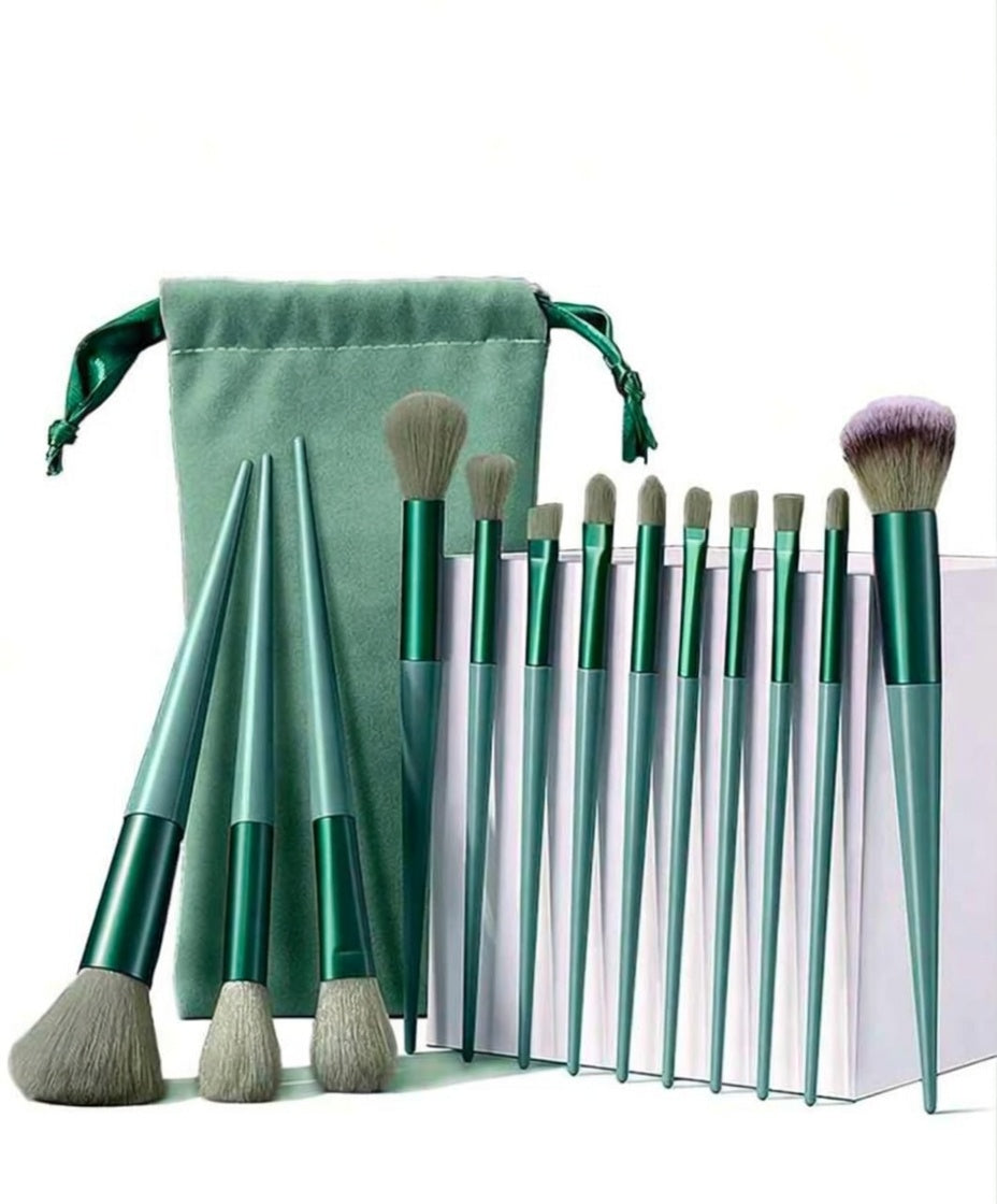 Set of 10 makeup brushes with green handles and silver ferrules, accompanied by a green drawstring bag on a white background.