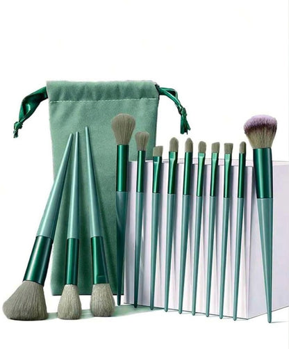 Set of 10 makeup brushes with green handles and silver ferrules, accompanied by a green drawstring bag on a white background.