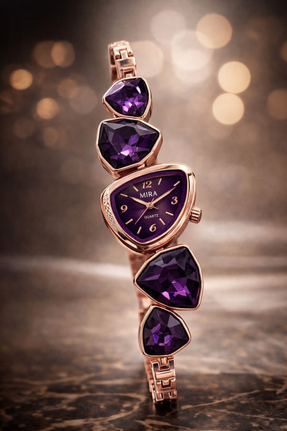 Rose gold watch with purple gemstones on a blurred background