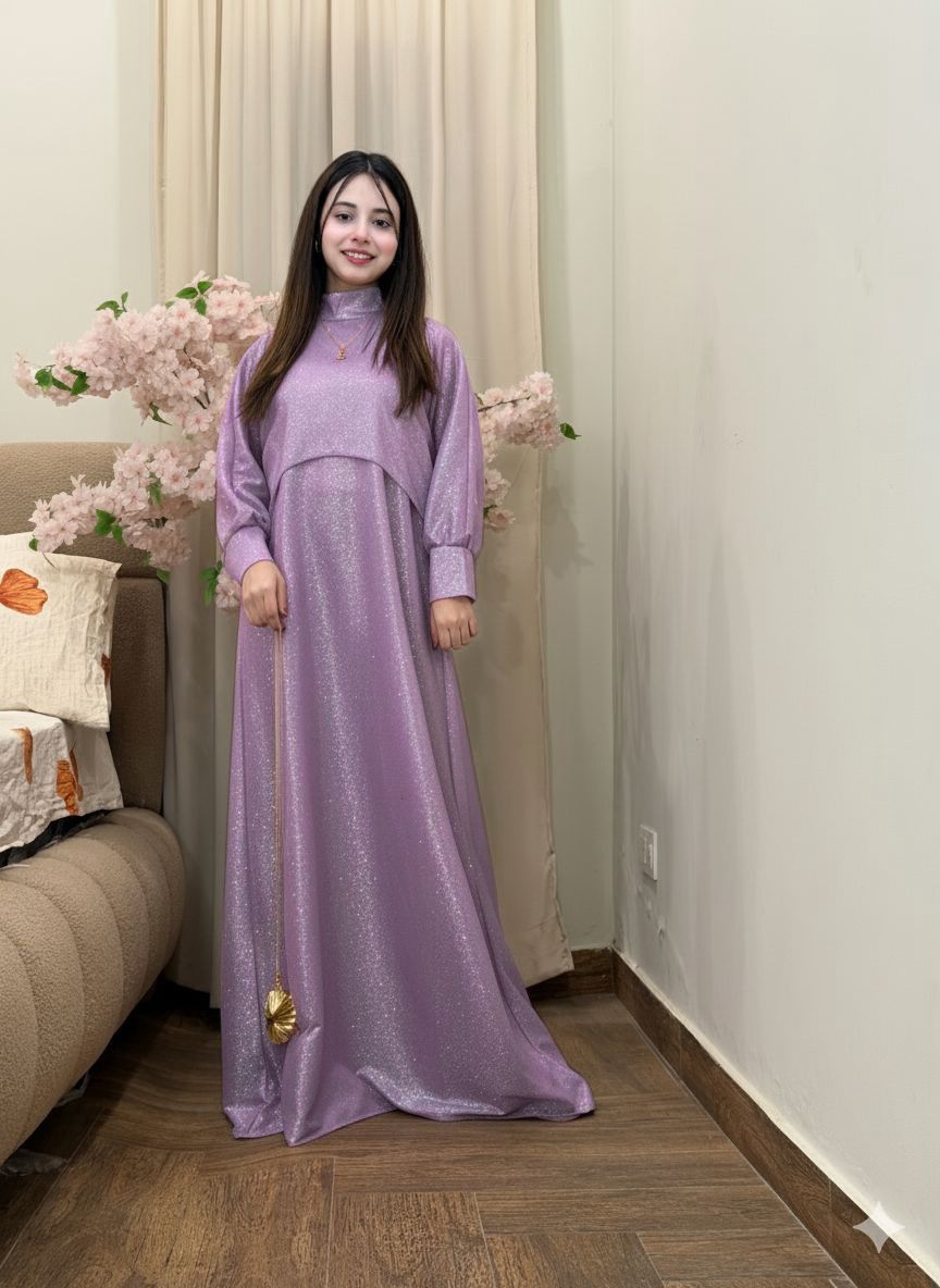 Woman in a long purple dress standing in a room with floral decorations.