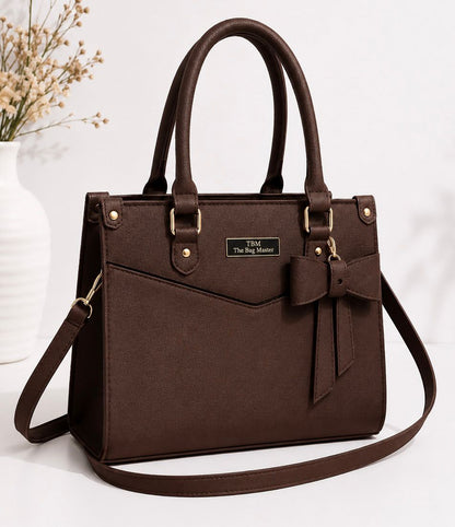 Brown handbag with a bow detail on a white background