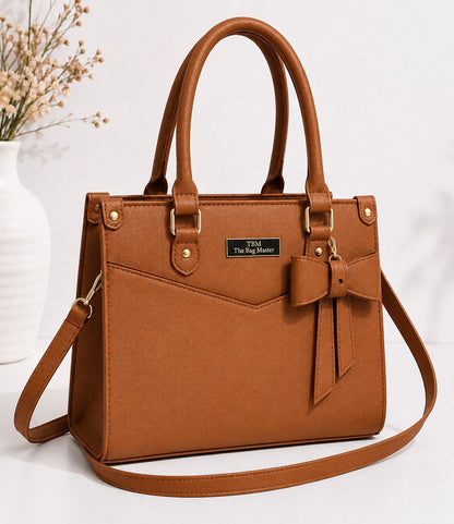 Orange handbag with a bow detail on a white background