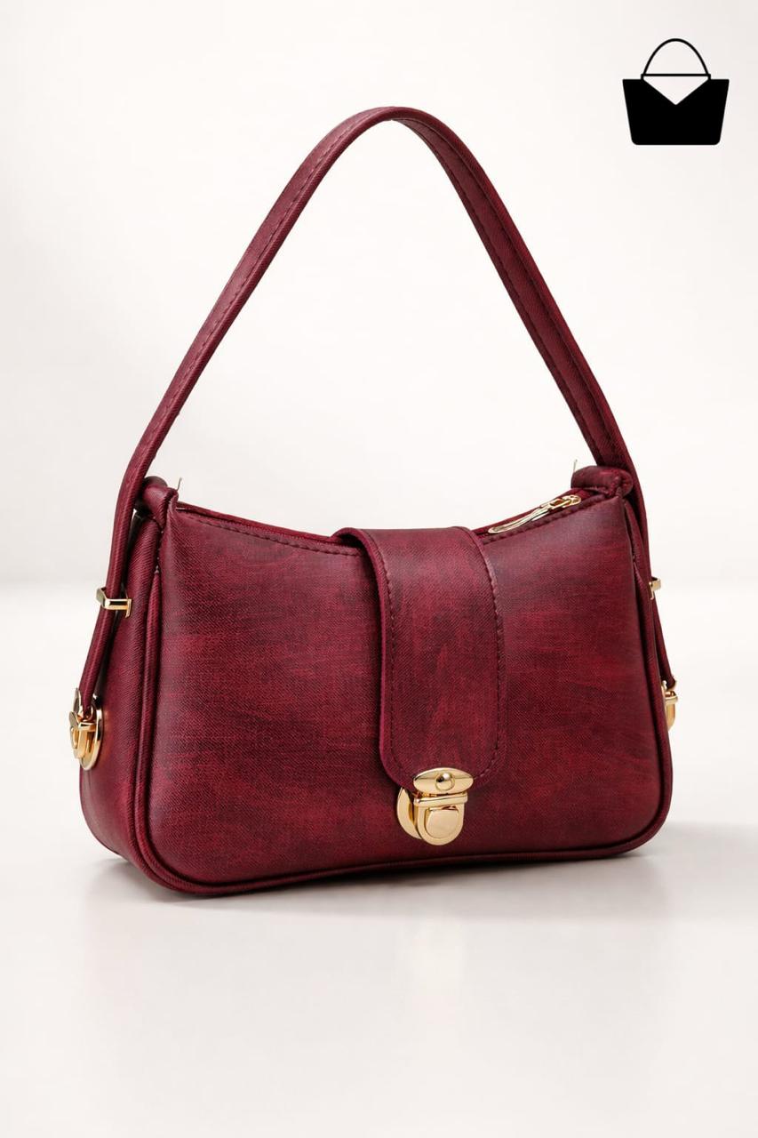 Red handbag with gold accents on a white background