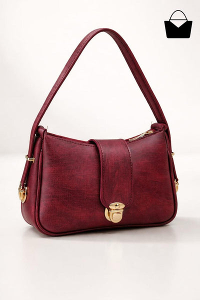 Red handbag with gold accents on a white background