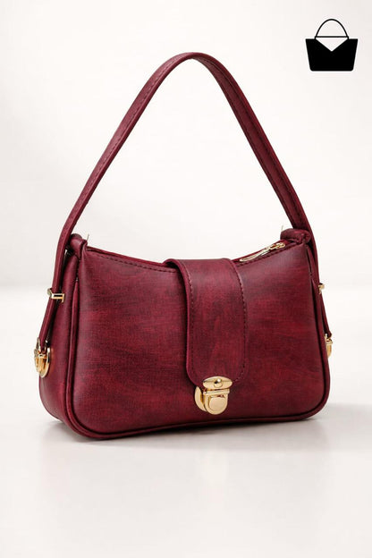 Red handbag with gold accents on a white background