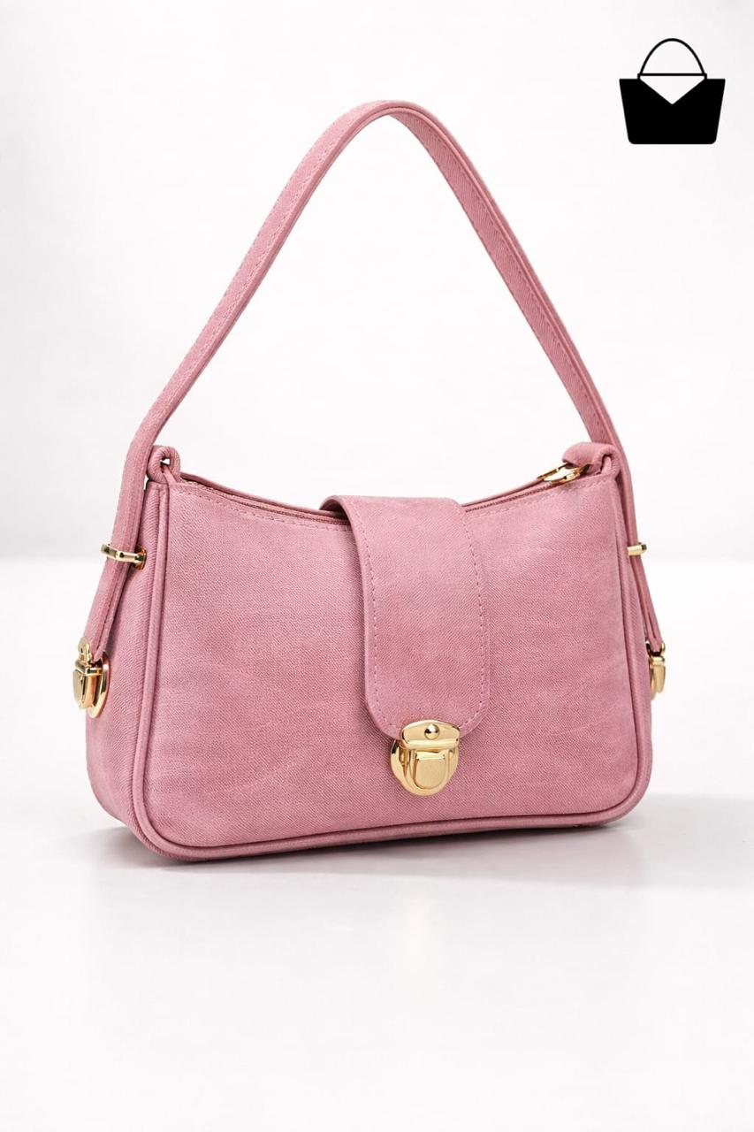 Pink handbag with gold accents on a white background
