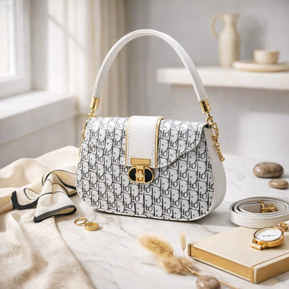 Patterned handbag with white handle on a light surface with accessories