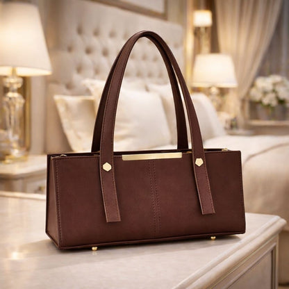 Brown handbag on a table with a blurred background
