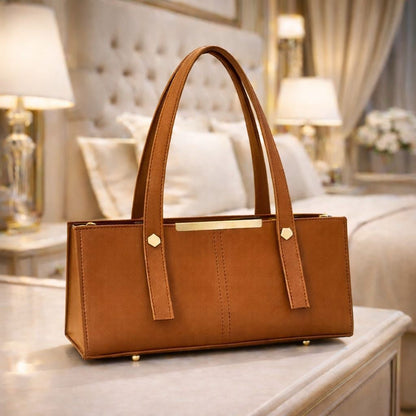 Orange handbag on a table with a blurred background