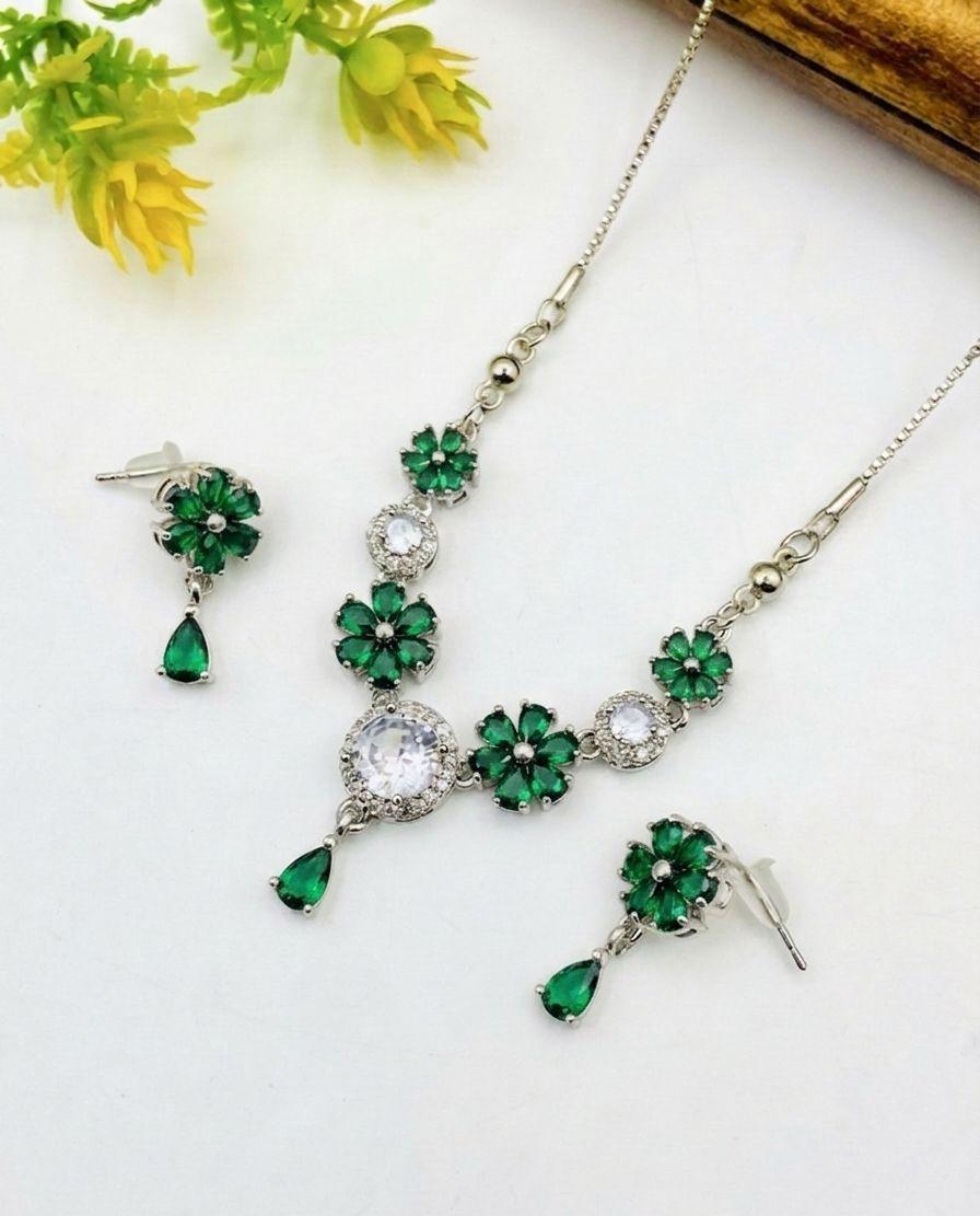 Jewelry set with green gemstones on a white background
