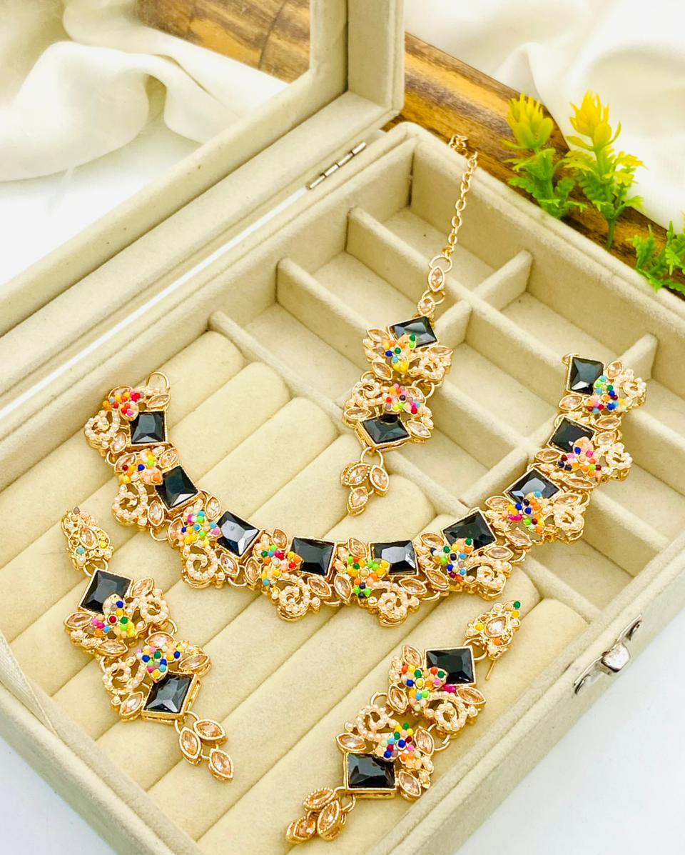 Gold necklace with colorful stones in a jewelry box