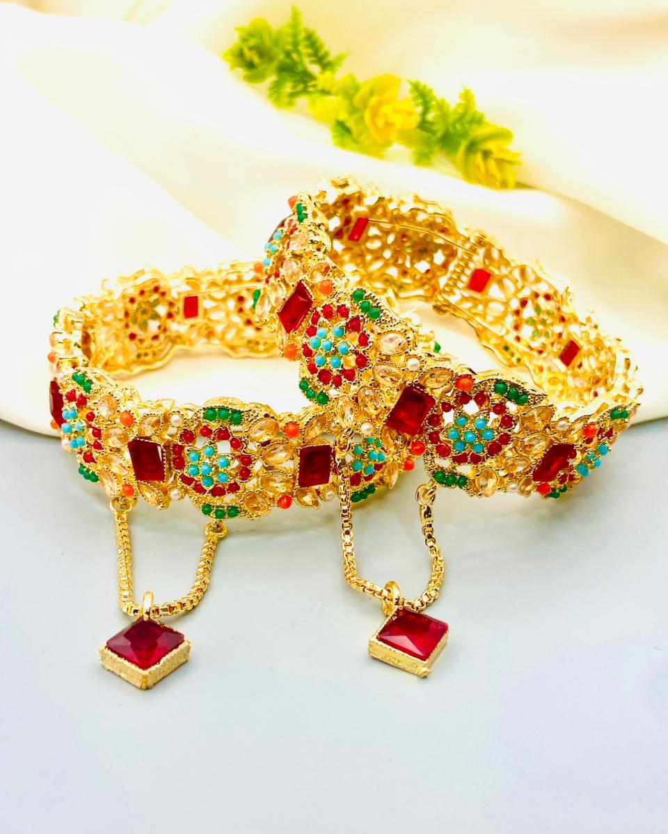 Gold bracelet with colorful stones on a white background