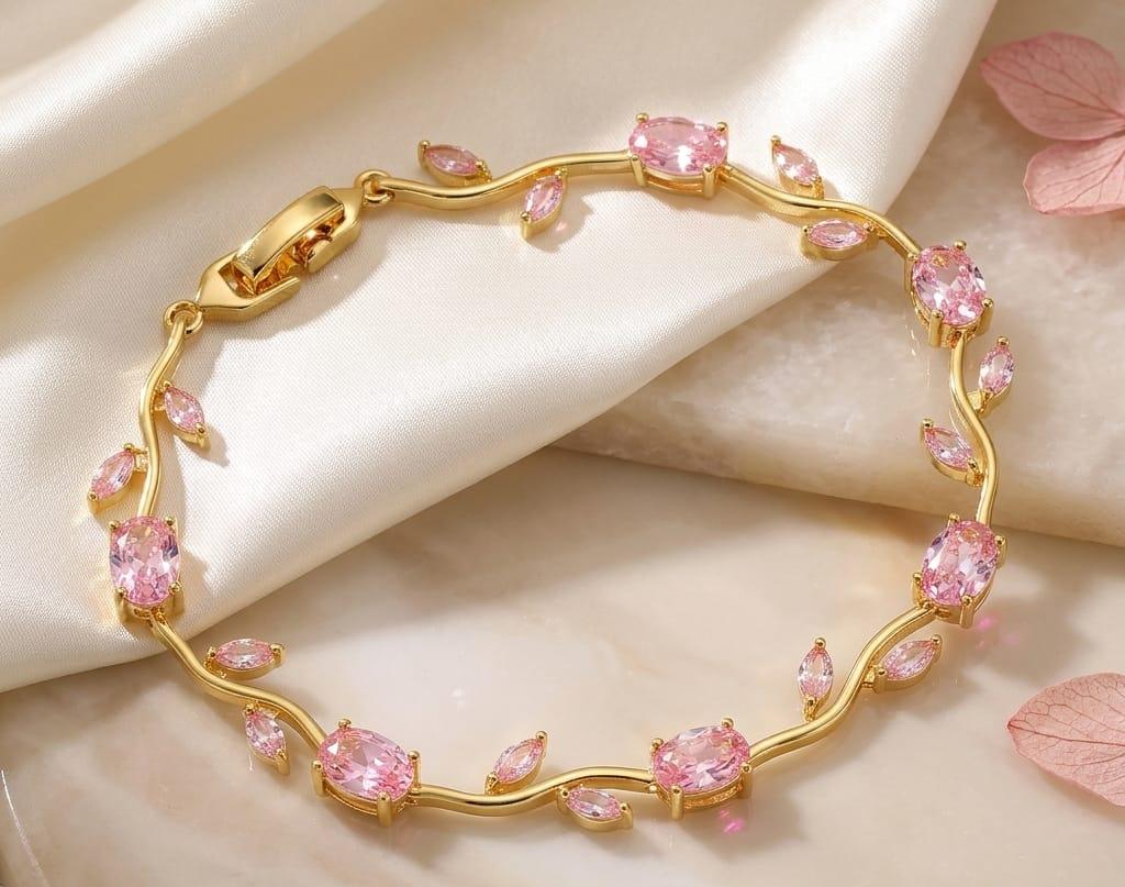 Gold bracelet with pink gemstones on a beige fabric background