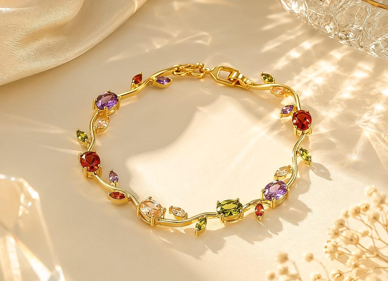 Gold bracelet with colorful gemstones on a soft fabric background
