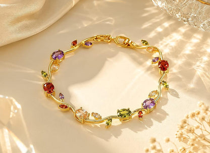 Gold bracelet with colorful gemstones on a soft fabric background