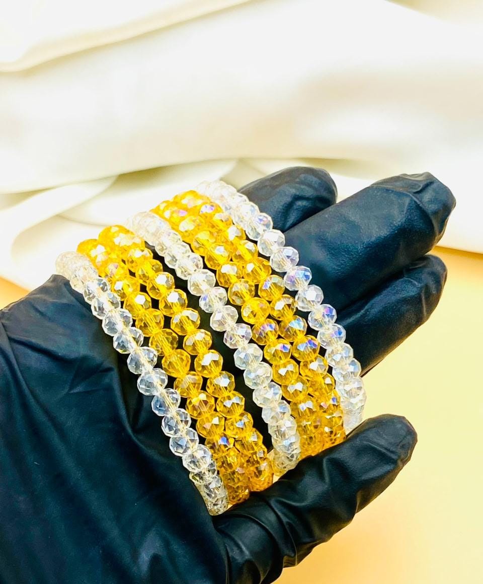 Elegant 7-piece yellow and clear crystal bracelet set for women featuring sparkling faceted beads, perfect for parties, weddings, gifting, and everyday fashion.