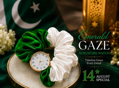 Emerald green and white satin scrunchie watch set on a marble tray with a gold-tone watch, decorated with a green flag and gold lantern in the background, featuring promotional text 'Emerald Gaze Scrunchie Watch' and '14 August Special'.